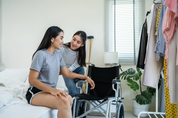 Disabled woman with amputated leg smiling with support worker